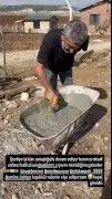 Person shoveling cement in mixing tub