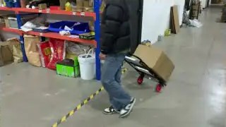 Person pushing heavy cart with both hands