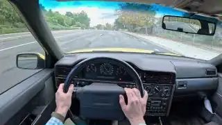 Both hands gripping steering wheel, turning