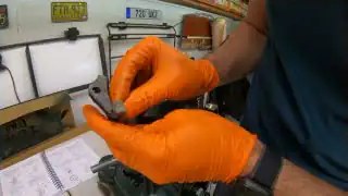 Gloved hands near industrial machine setup